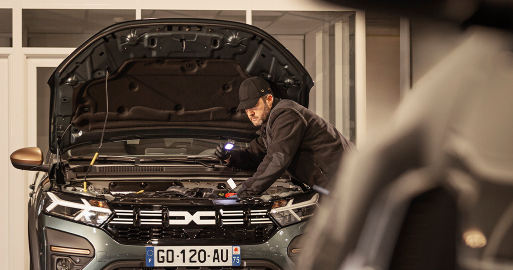 En Dacia med öppen motorhuv i en märkesverkstad