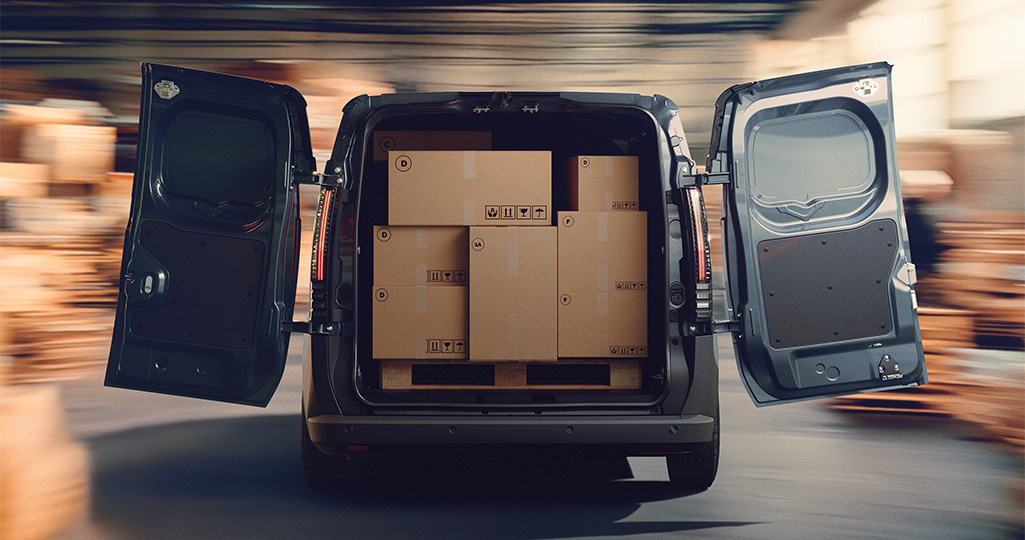Renault E-Tech electric har bakdörrarna öppna och bilen är fullt packad med paket